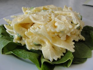 creamy bowtie pasta salad on a bed of lettuce