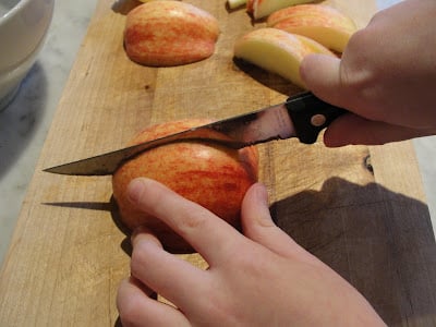 child slicing an apple