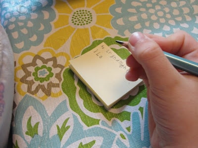 child writing on a post it note