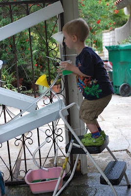 child playing with water wall