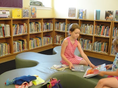 kids reading books at library