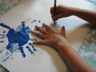 child's hand on paper