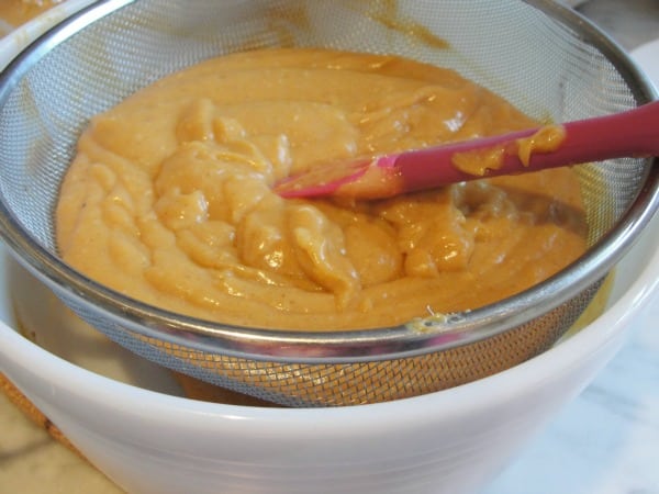 straining custard to remove lumps