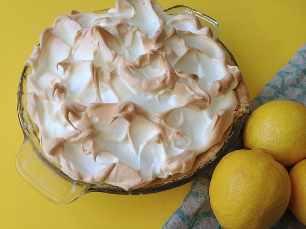 lemon meringue pie surrounded by lemons