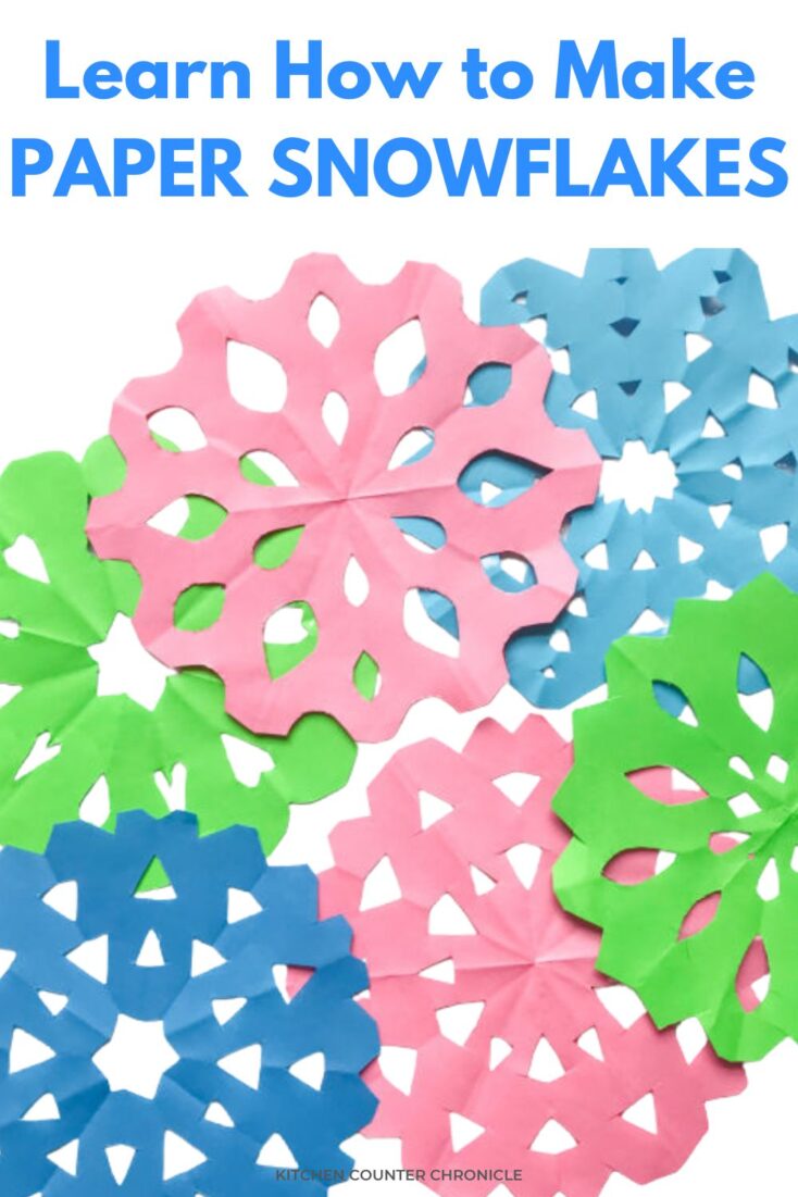 Learn How to Make Paper Snowflakes with a pile of paper snowflakes