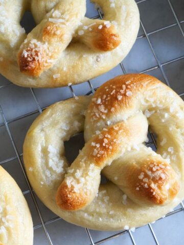 close up of soft pretzel on cooling rack