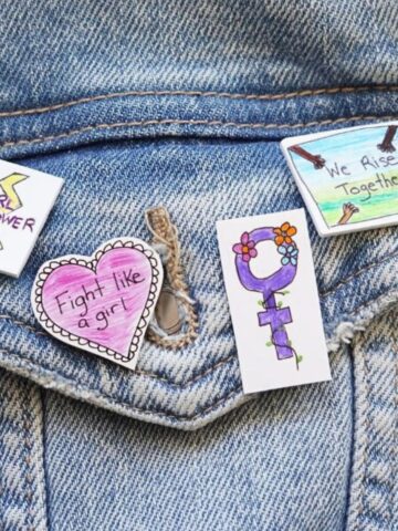 close up of IWD craft pins diy on jean jacket pocket