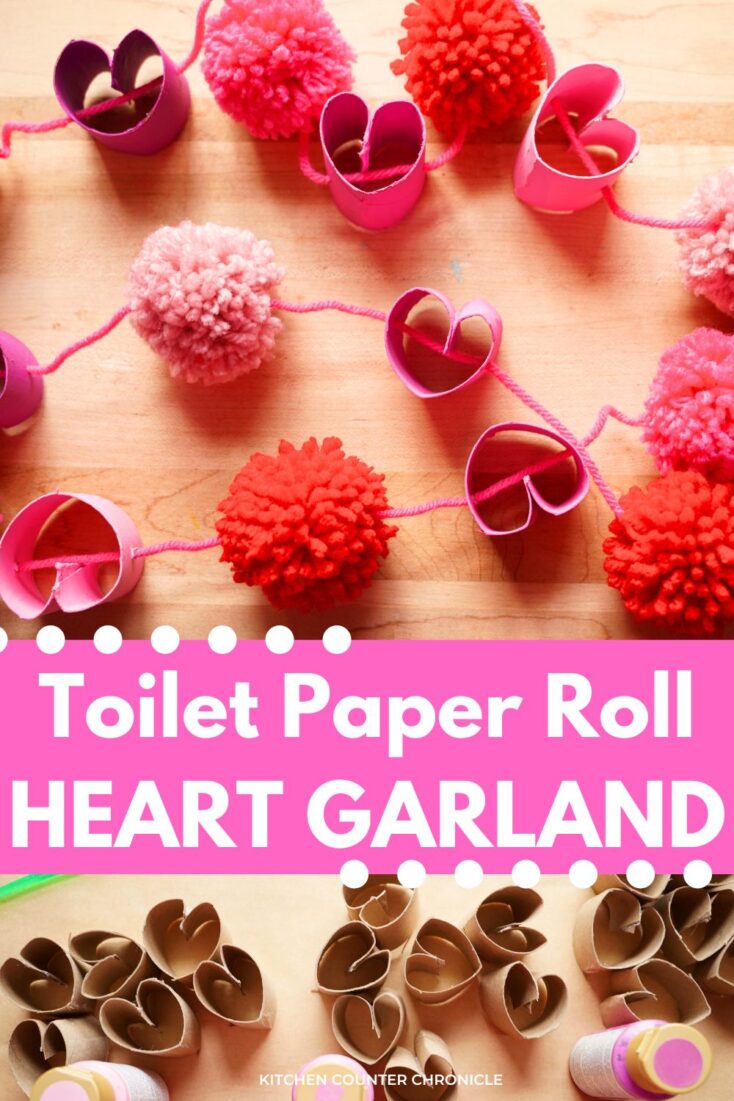 close up of pink Toilet Paper Roll heart garland with pom poms valentine's day craft