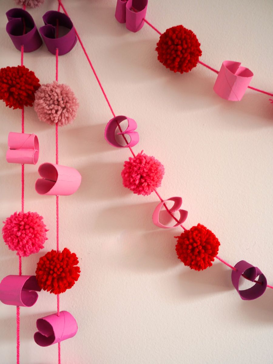 toilet paper roll heart garland hanging on wall