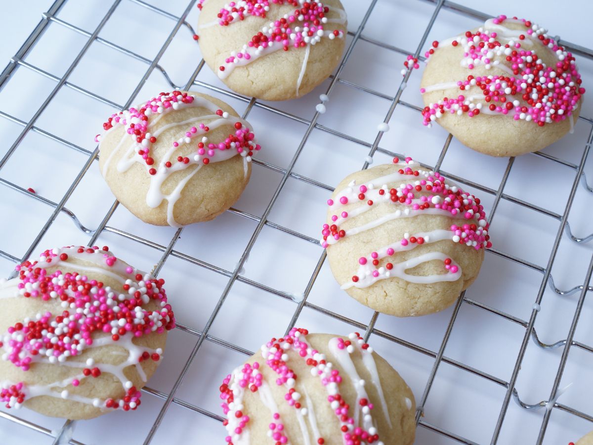 valentine cookies with pink sprinkles on cooling rack