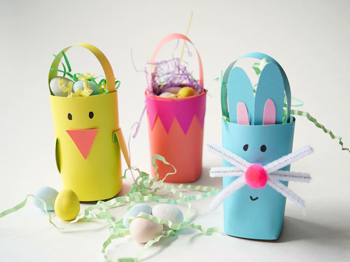 3 toilet roll easter baskets filled with easter grass and chocolate easter eggs