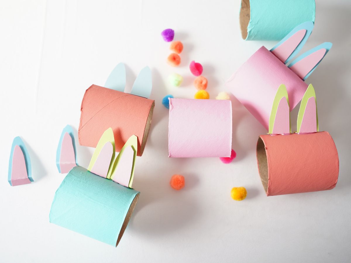 bunny ears being blued on toilet rolls and a pile of pompoms