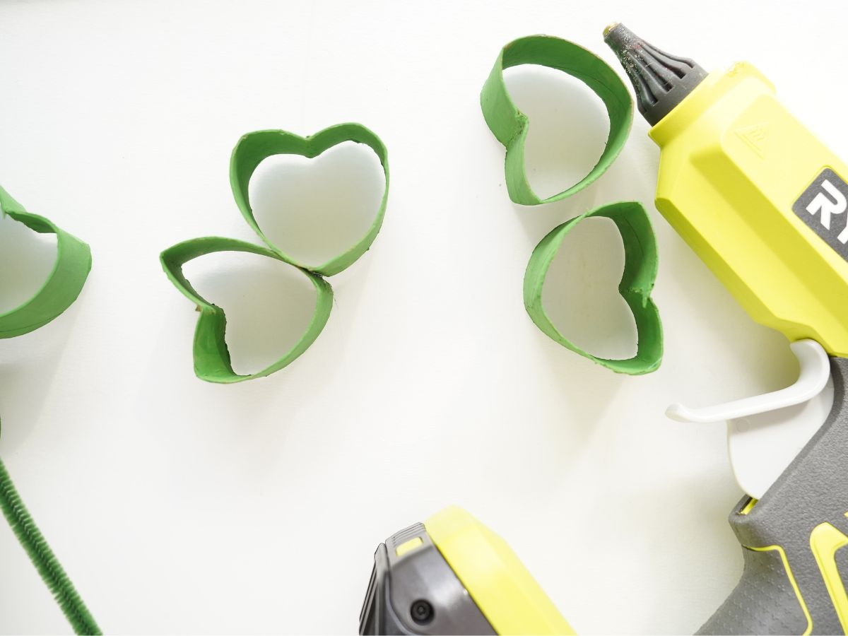 glue gun with paper roll shamrock leaves being glued together