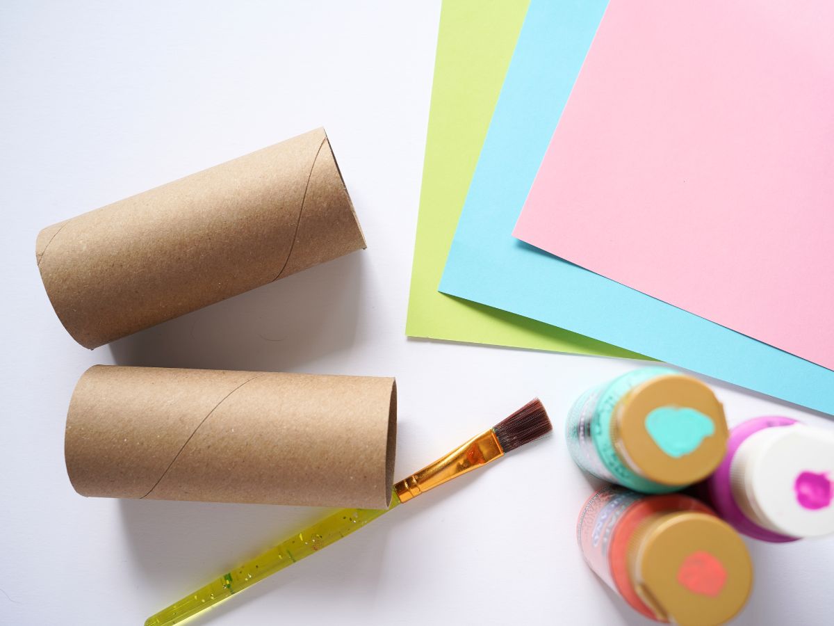 supplies for making easter bunny toilet paper roll craft - paint brush, paper rolls and paint